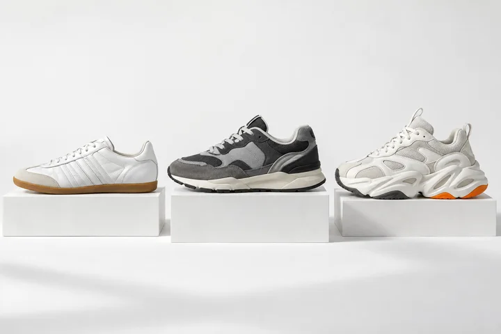 Three unbranded sneaker design concepts with slim, layered and sculpted shapes on white plinths.