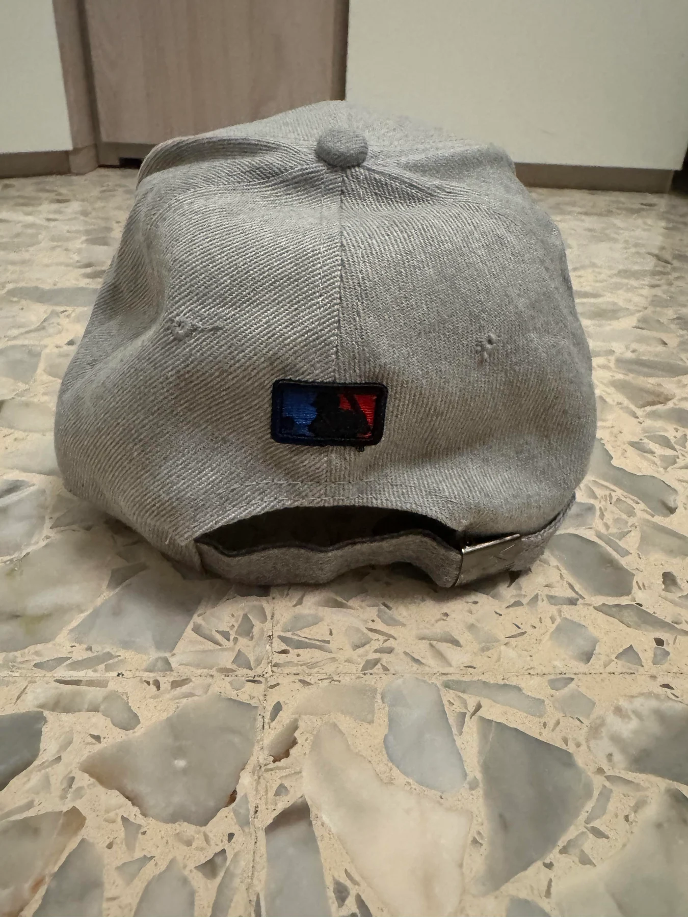 Back of the grey baseball cap.