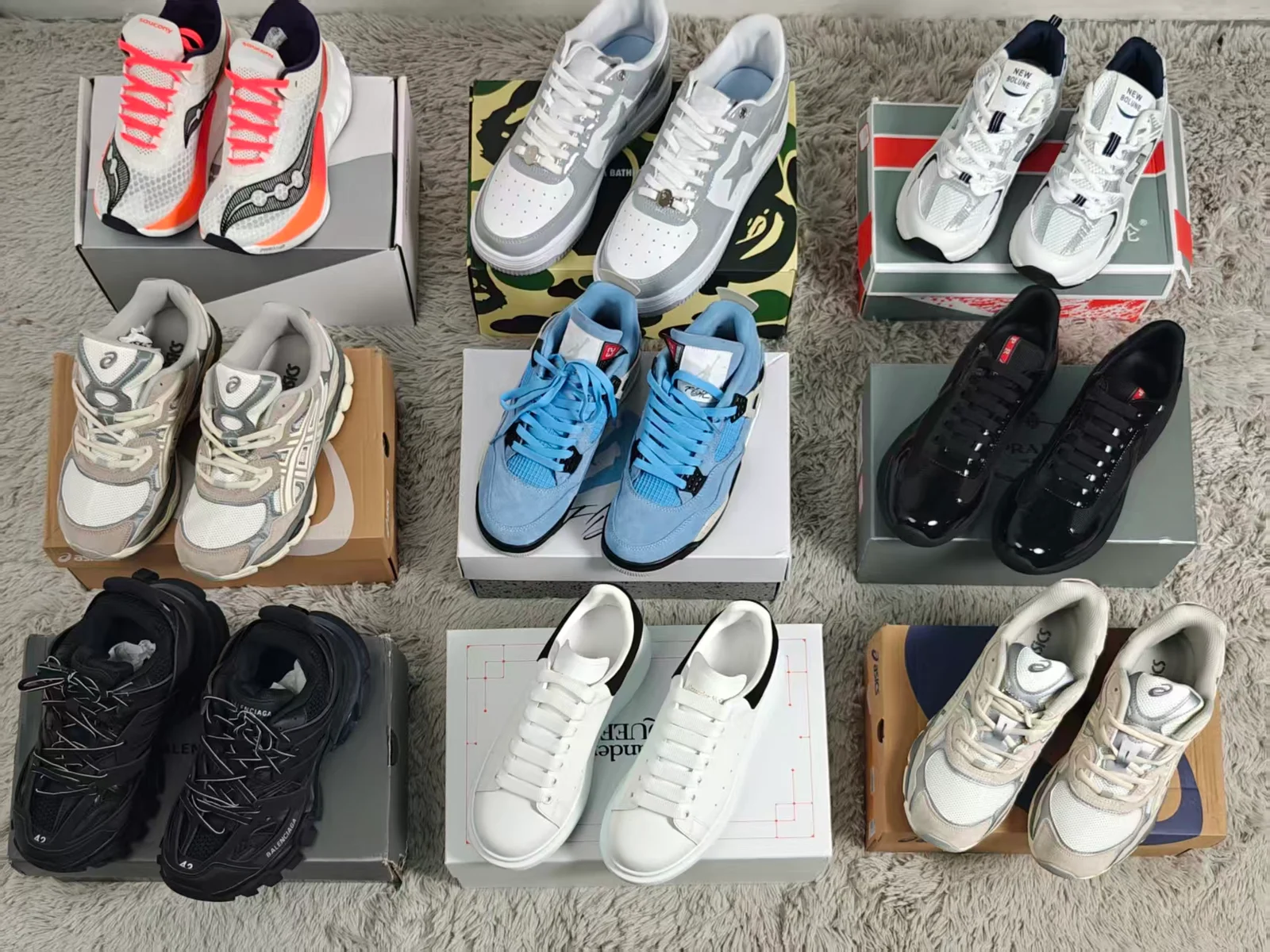 Nine pairs of sneakers arranged on boxes.